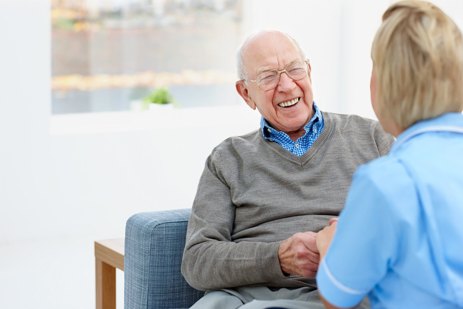 A senior man talking to a caregiver